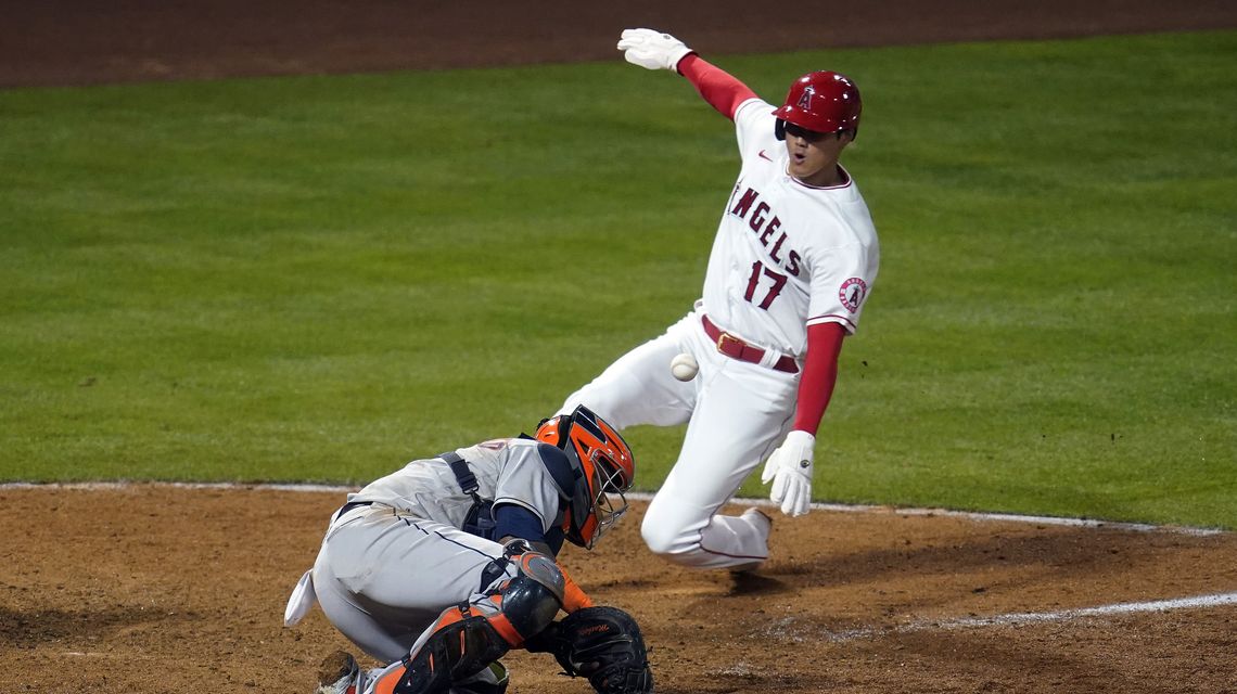 Trout homers, Angels rally in 8th to hand Astros first loss