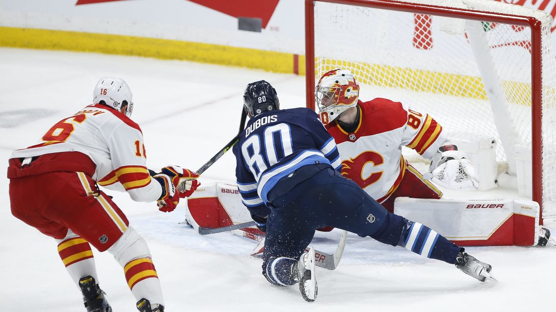 Connor Hellebuyck makes 32 saves, Jets beat Flames 3-1