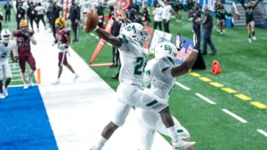 Amir Herring celebrates a touchdown with Mekhi Elam in Michigan's state title game. 