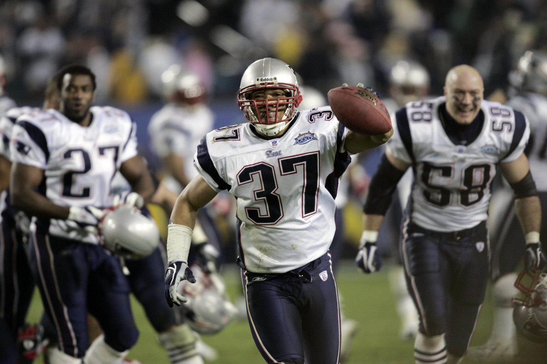 New England Patriots safety Rodney Harrison is dressed for the cold as he  stands on the stadium field as practice begins at the NFL football team's  facility in Foxborough, Mass., Thursday afternoon