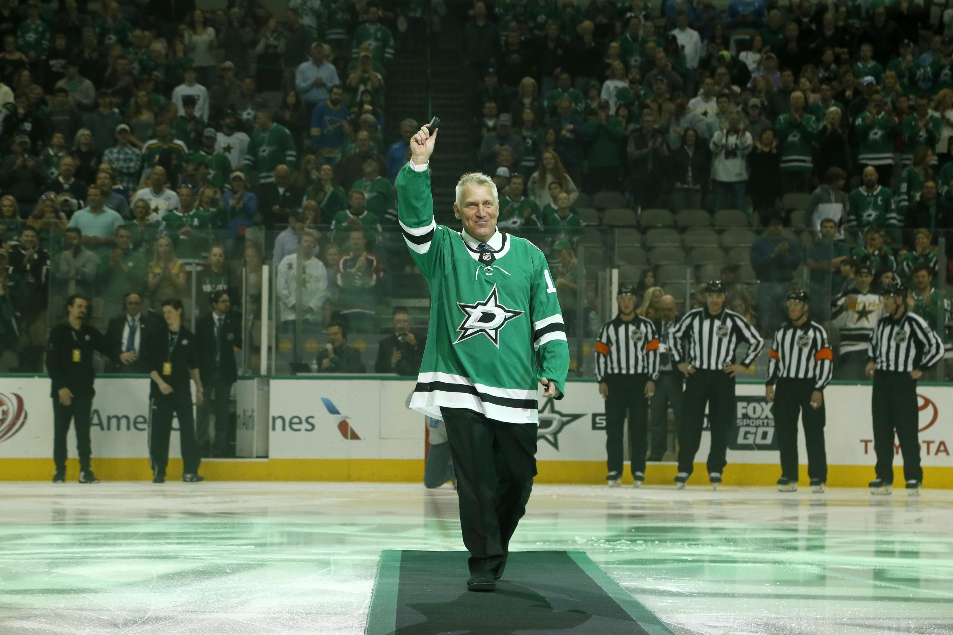 Dallas Stars former player Brett Hull waves to the crowd after a ceremonial puck drop before the game at American Airlines Center. 