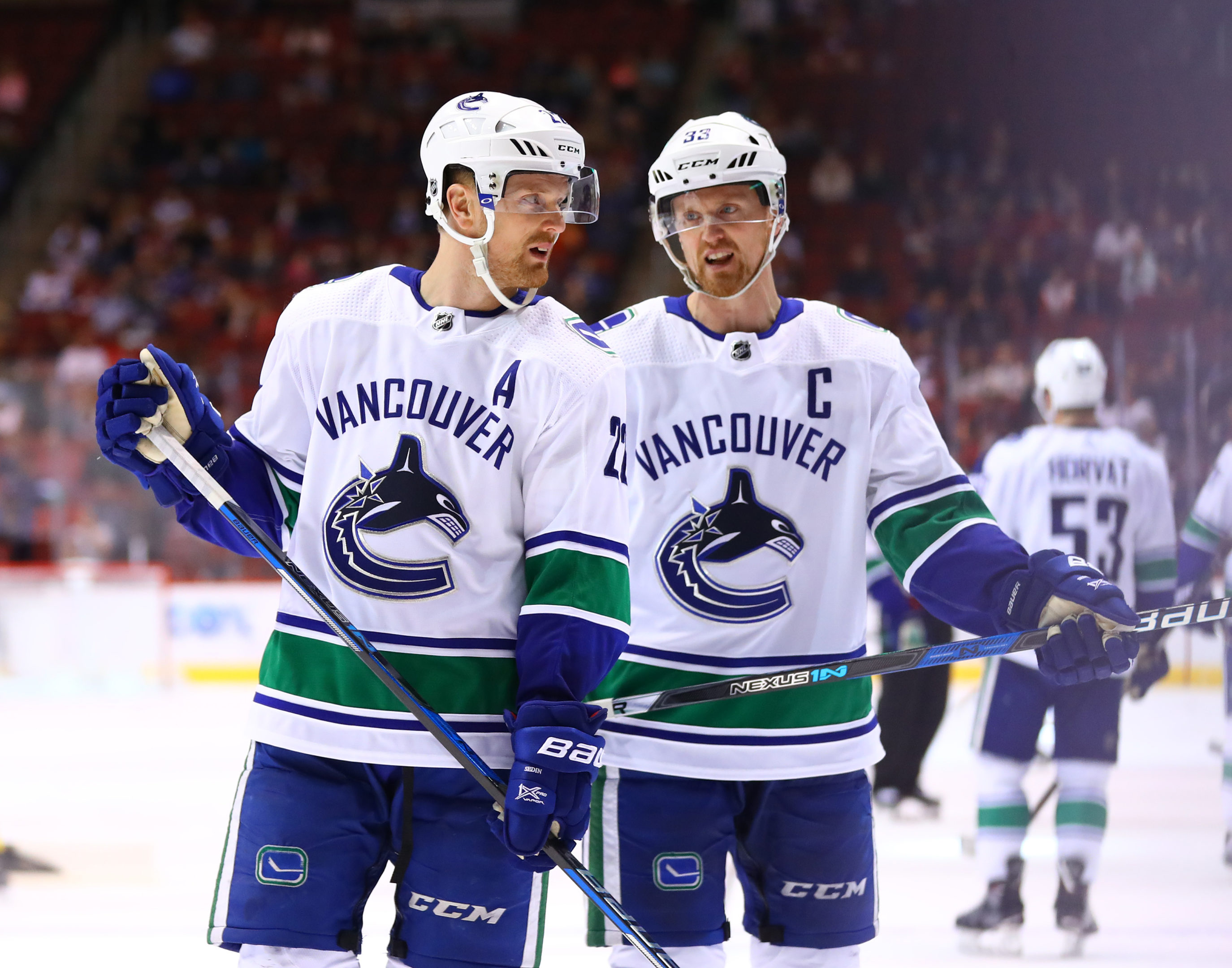 Vancouver Canucks left wing Daniel Sedin (left) with identical twin brother center Henrik Sedin.