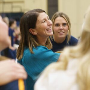 Eau Claire volleyball coach Kim Wudi demonstrates Tru Blue spirit